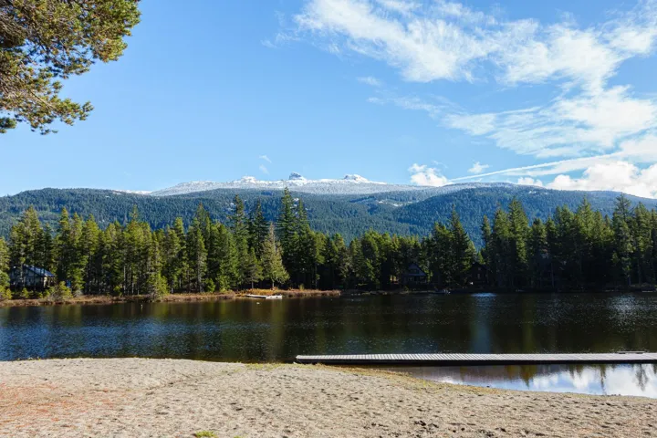 View of lake with a mountain view and a view of trees