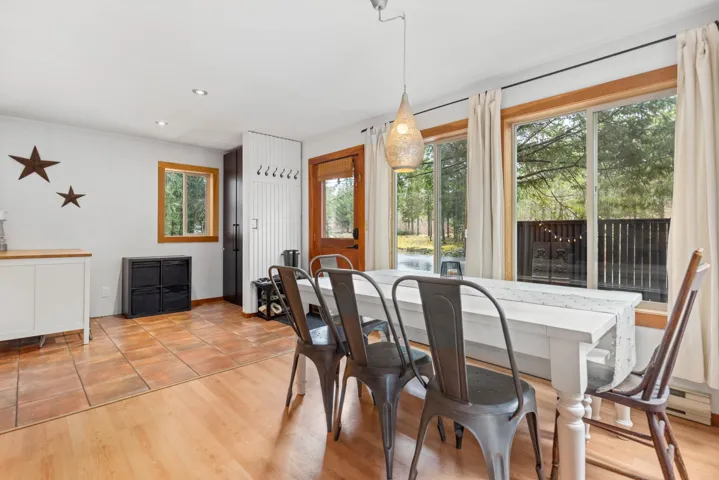 Dining room with light wood-style floors and recessed lighting