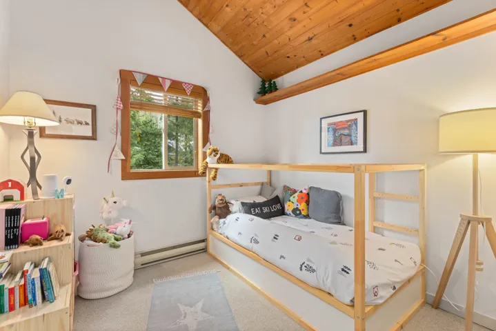 Bedroom featuring wood ceiling, carpet, lofted ceiling, and a baseboard heating unit