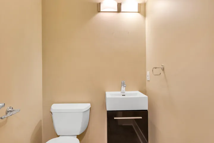 Half bathroom featuring vanity and toilet on main level