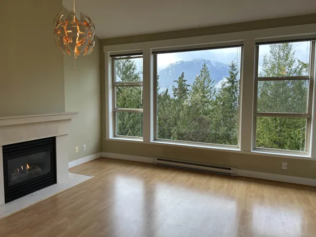 Open living room with gas fireplace and balcony access. Southwest views.  Very bright