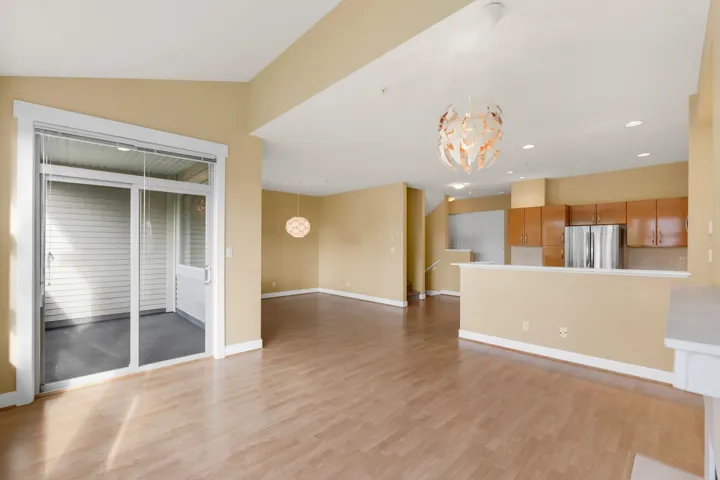 Unfurnished living room with a chandelier, light wood finished floors, and recessed lighting