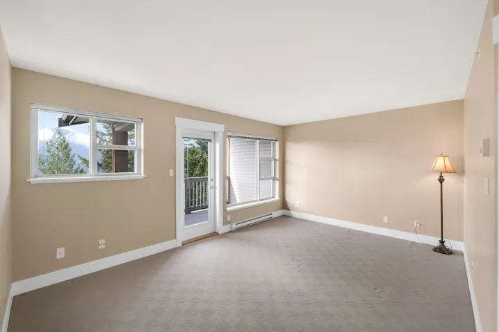 Primary bedroom located on the entire upper floor with balcony overlooking the mountains and peek-a-boo water views