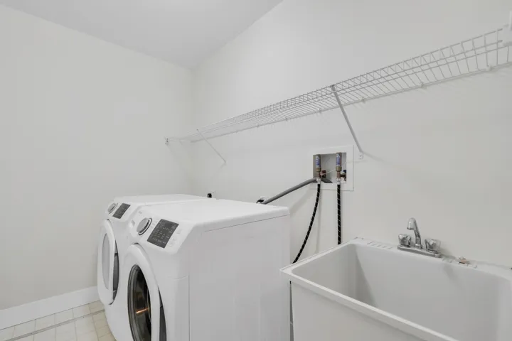 Laundry room with washer and clothes dryer