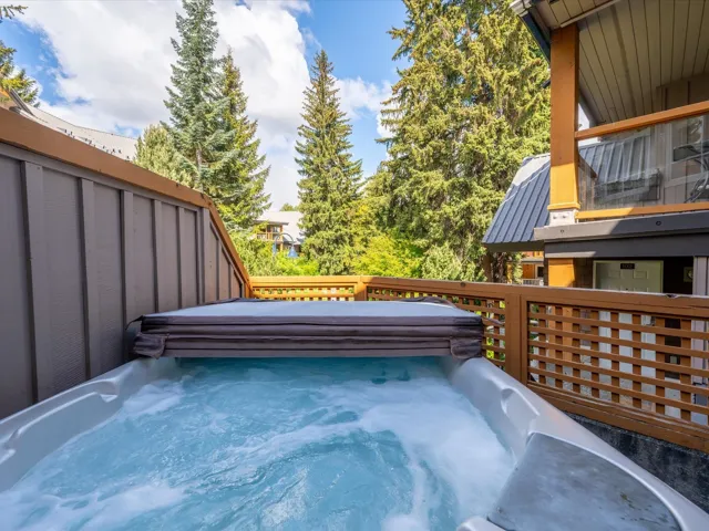 Wooden terrace featuring a hot tub