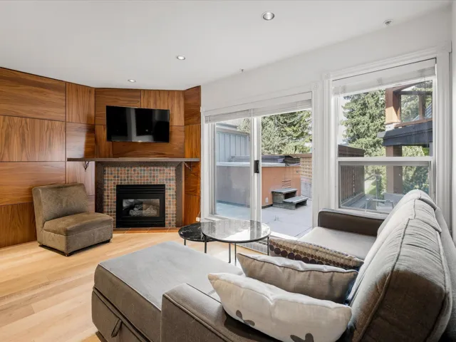 Living room with healthy amount of natural light, light wood finished floors, a fireplace, and recessed lighting