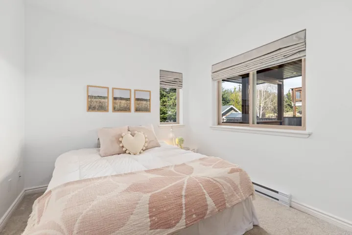 Bedroom with a baseboard radiator, carpet flooring, and baseboards