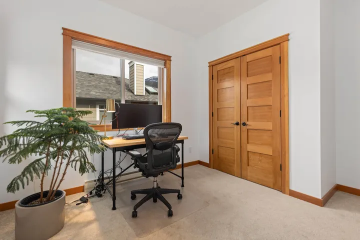 Home office with carpet and baseboards