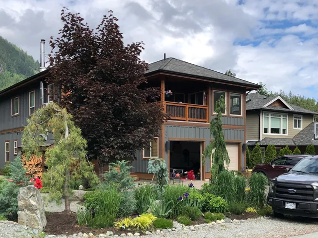 View of front of property featuring a balcony, board and batten siding, and roof with shingles