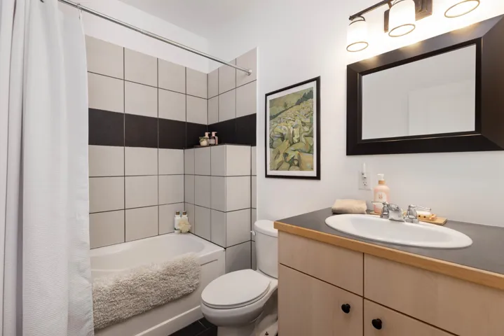 Bathroom featuring vanity, toilet, and shower / tub combo with curtain