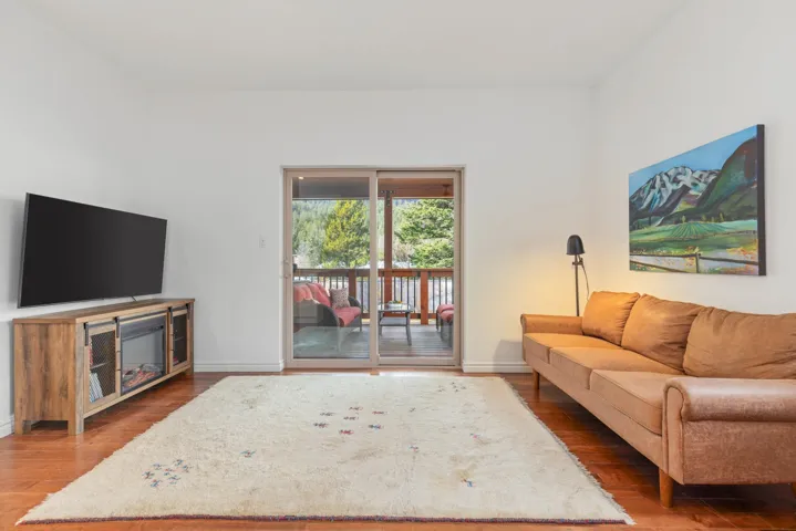 Living area featuring baseboards and wood finished floors