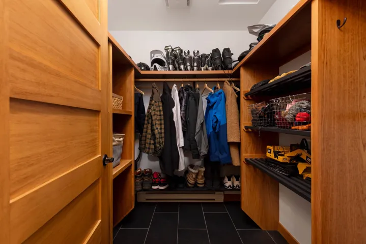 Walk in closet with dark tile patterned flooring and baseboard heating