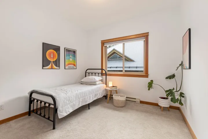Bedroom featuring a baseboard heating unit, carpet flooring, and baseboards
