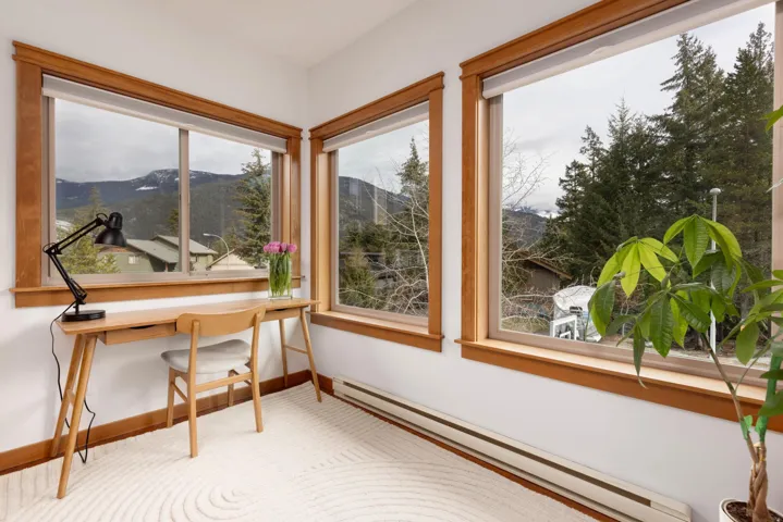 Home office with a baseboard heating unit, a mountain view, and baseboards