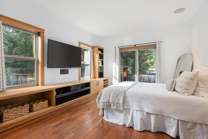 Bedroom with wood-type flooring and access to exterior