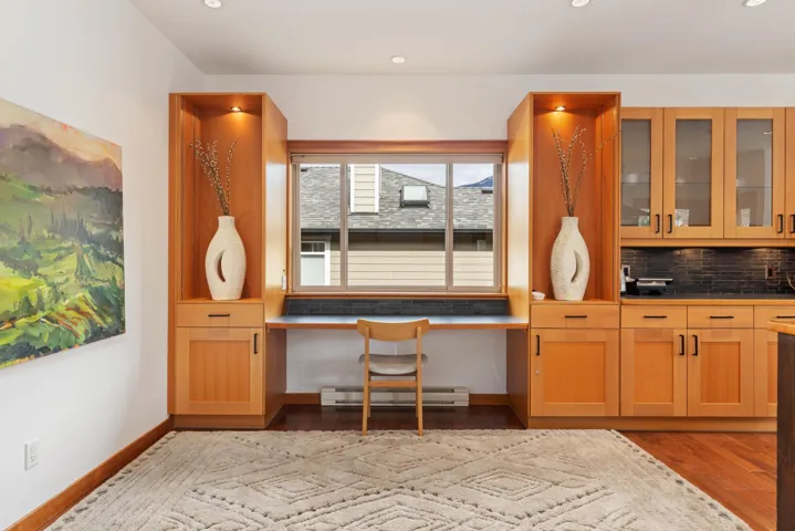 Interior space with baseboards, built in study area, light wood-style flooring, a baseboard heating unit, and recessed lighting