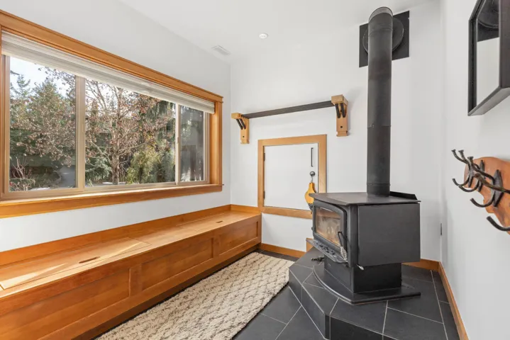 Room details featuring a wood stove, visible vents, and baseboards