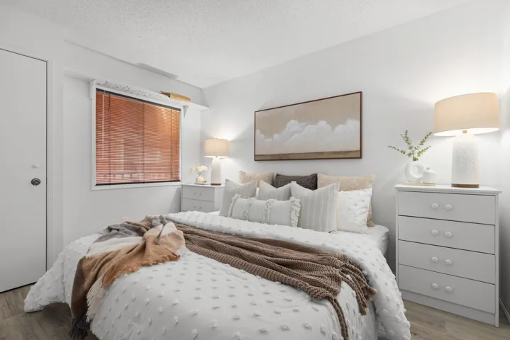 Bedroom with wood finished floors and a textured ceiling