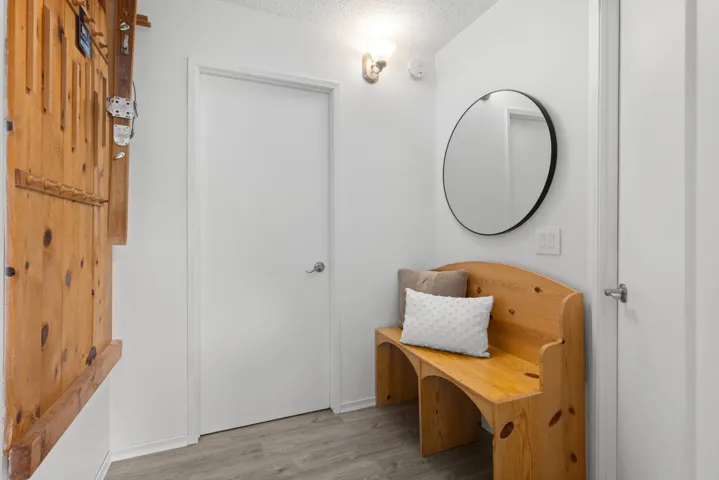Mudroom with light wood-style flooring and a textured ceiling