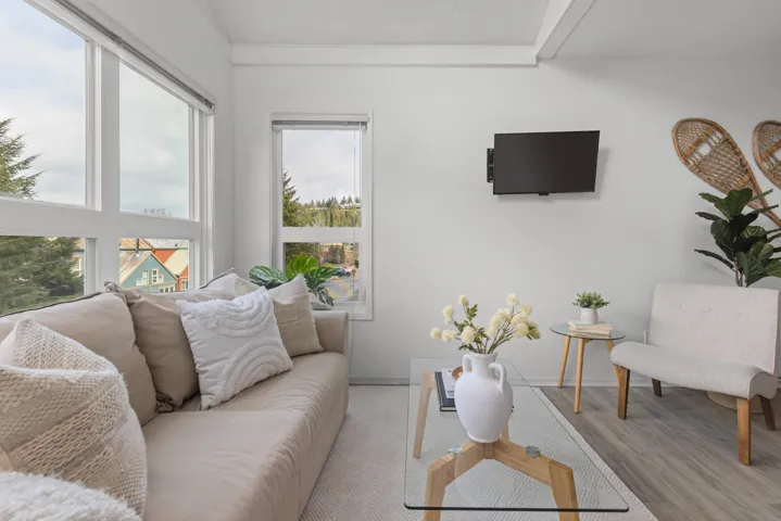 Living area with wood finished floors and baseboards