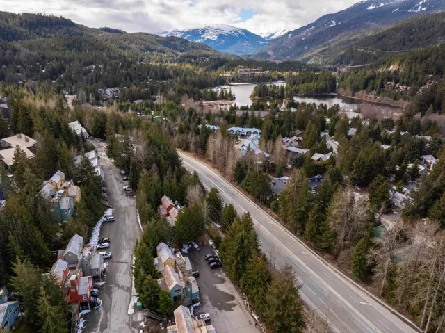 Bird's eye view of a water and mountain view and a forest