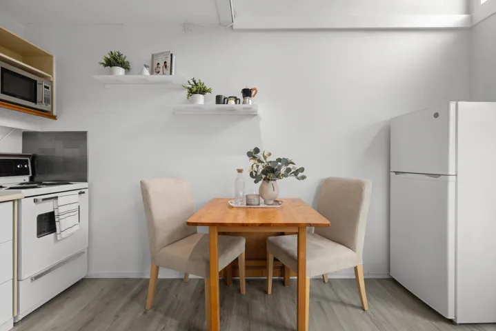 Dining area featuring light wood-style flooring and baseboards