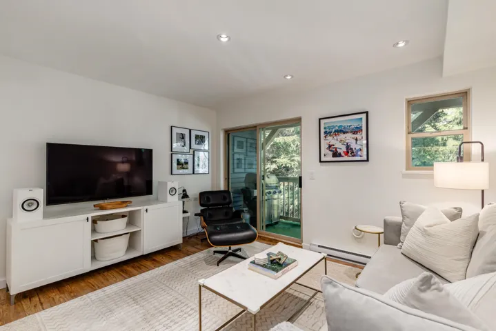 Living room featuring recessed lighting, baseboard heating, and wood finished floors