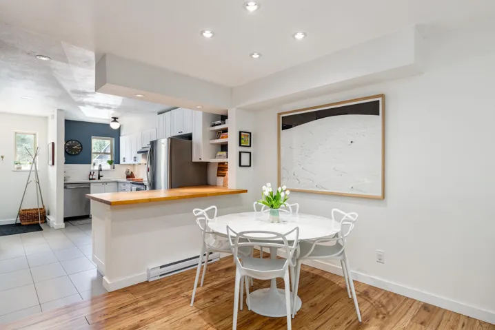 Dining space with baseboards, recessed lighting, a baseboard heating unit, and light wood-style floors