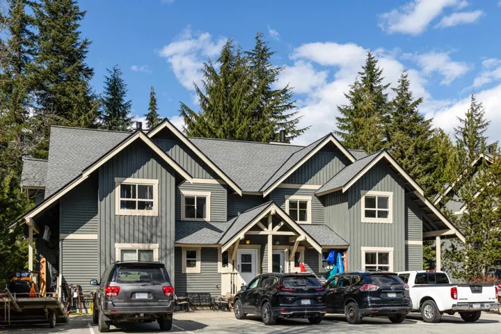 View of front of home featuring board and batten siding and roof with shingles