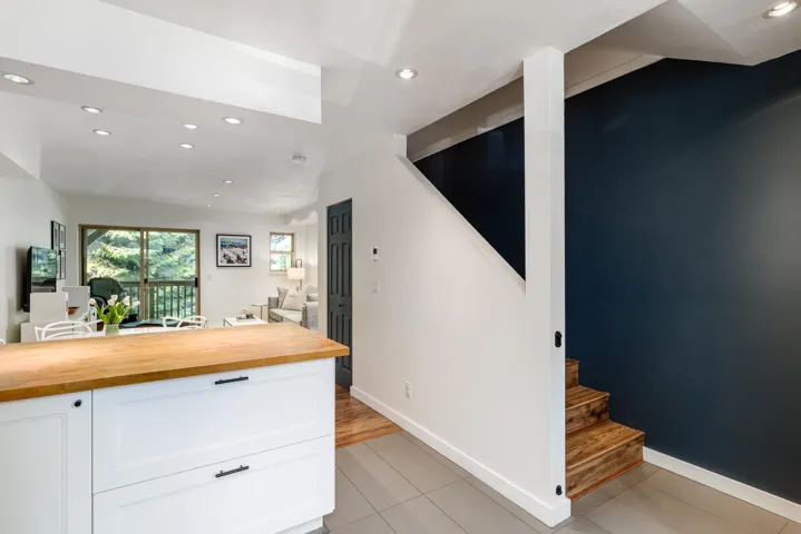 Kitchen featuring white cabinetry, recessed lighting, wood counters, and light tile patterned flooring