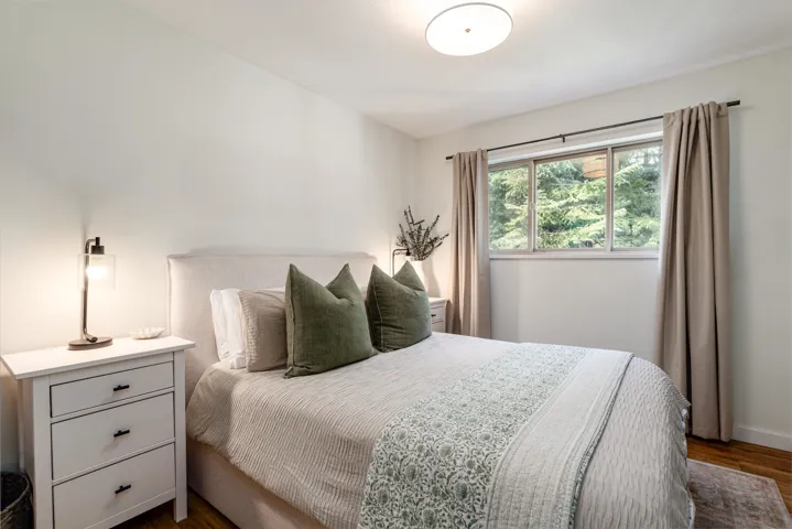 Bedroom featuring dark wood-type flooring and baseboards