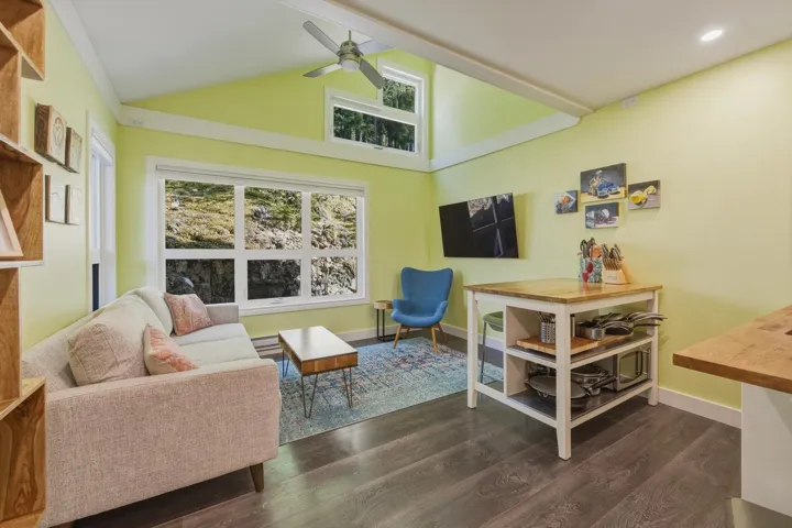 Vaulted ceiling with an exposed beam and ceiling fan