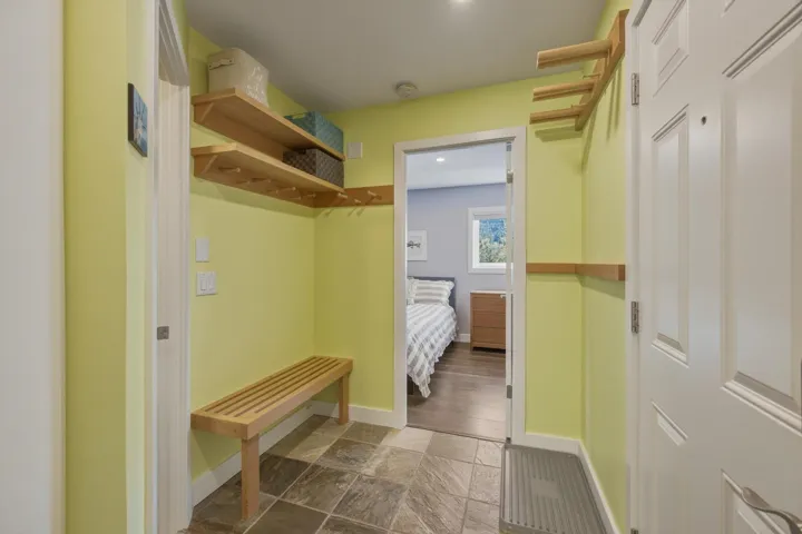 Entryway featuring slate tile flooring and a built-in wooden bench