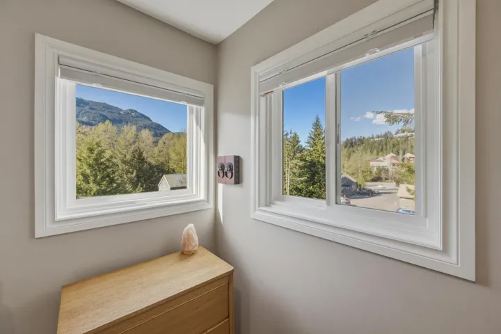Dual windows with white trim and roll-down blinds