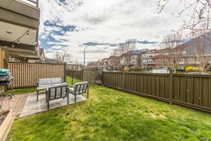 View of yard featuring a patio area, a fenced backyard, a residential view, and an outdoor hangout area