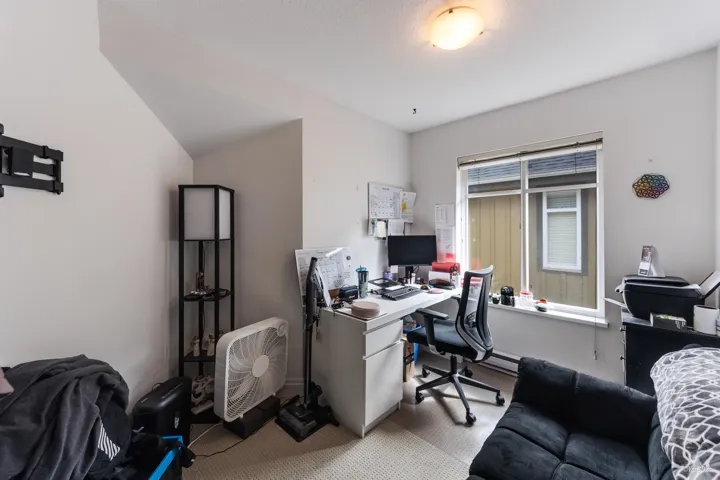 Office space featuring a baseboard radiator and carpet flooring