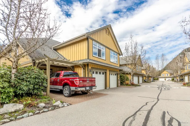 View of front of property with an attached garage, board and batten siding, and concrete driveway