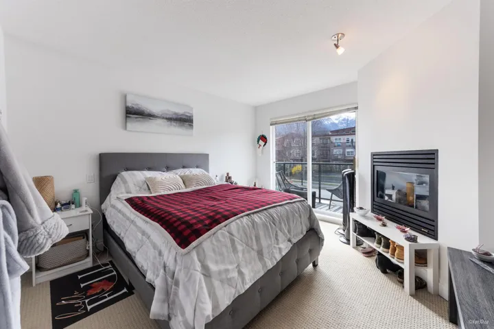 Carpeted bedroom featuring access to exterior