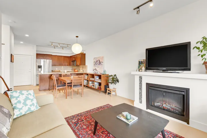 Living room with track lighting, a fireplace, and recessed lighting