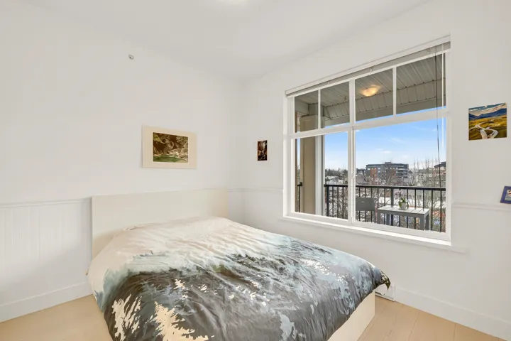 Bedroom featuring baseboards, wood finished floors, and a view of city