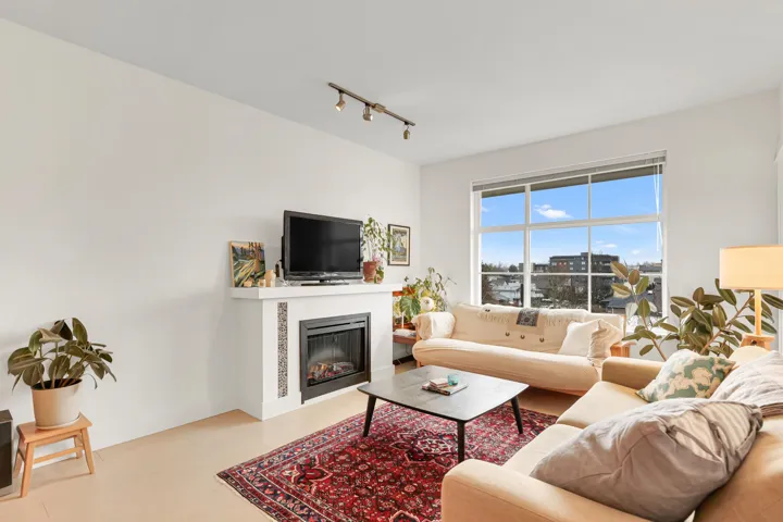 Living area with a glass covered fireplace and track lighting