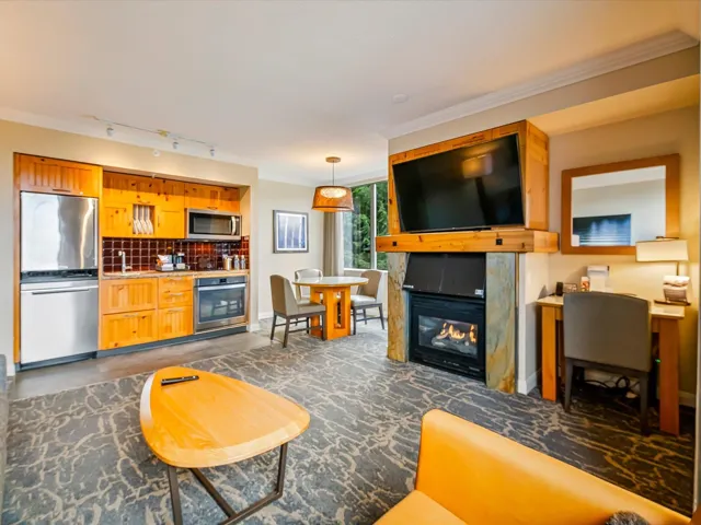 Living area featuring rail lighting, a fireplace, baseboards, and ornamental molding