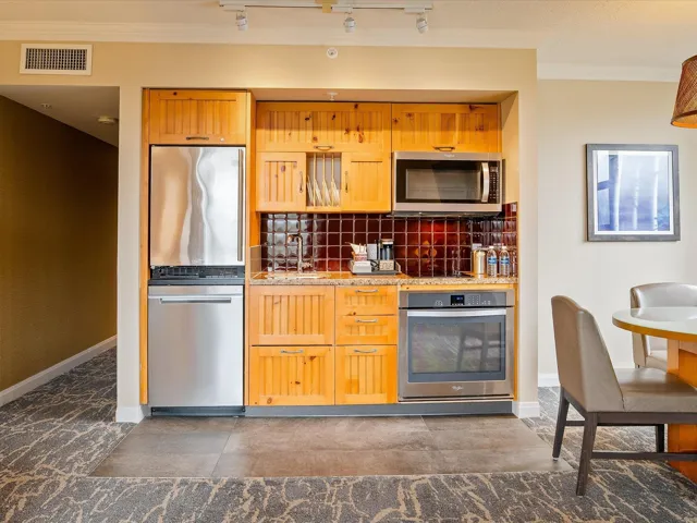 Kitchen featuring ornamental molding, track lighting, backsplash, visible vents, and stainless steel appliances