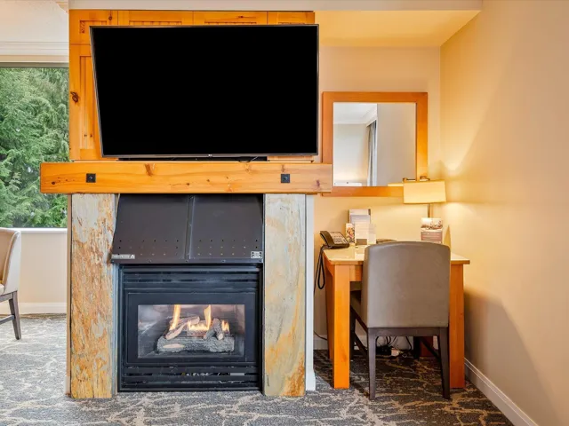 Interior details featuring baseboards, a multi sided fireplace, and carpet floors