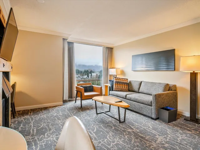 Living room featuring floor to ceiling windows, baseboards, ornamental molding, and carpet floors