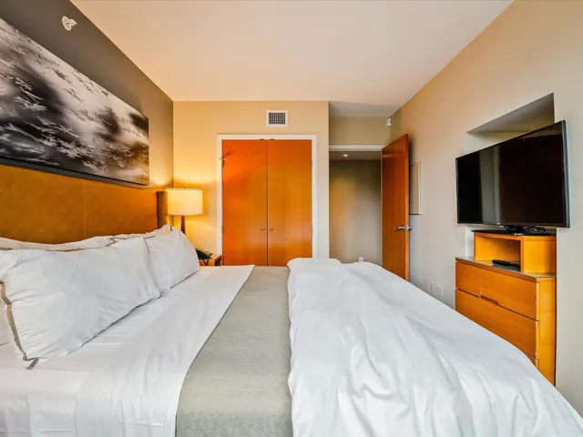 Bedroom with visible vents and a closet