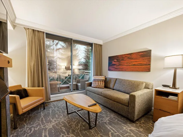 Living room with crown molding and floor to ceiling windows