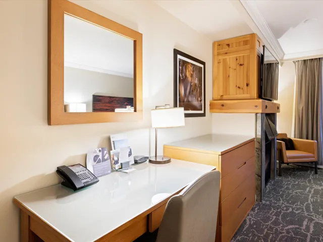 Office with crown molding and dark carpet