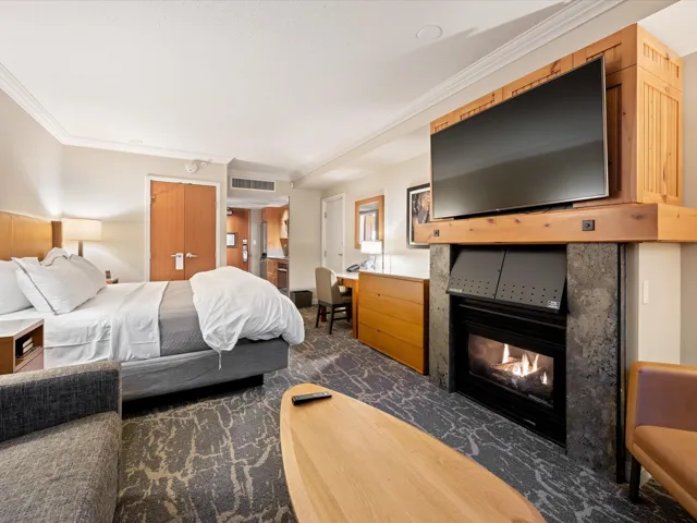 Bedroom featuring ornamental molding, a fireplace, a closet, and a desk