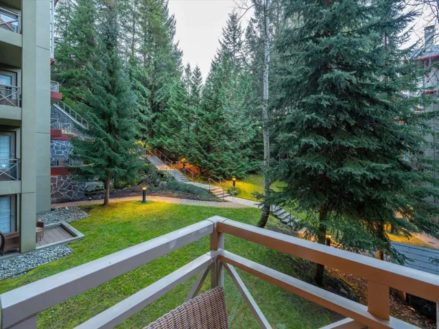 View of grassy yard with a balcony